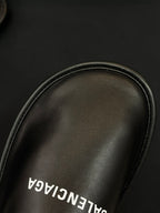 Black leather slide upper close-up with BALENCIAGA insole lettering
