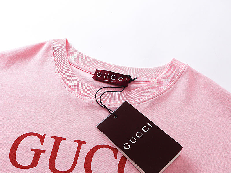 Pink T-shirt neckline with Gucci label and red logo print, with tag attached