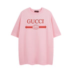 Pink T-shirt with Gucci logo graphic on chest, short sleeves, crew neck