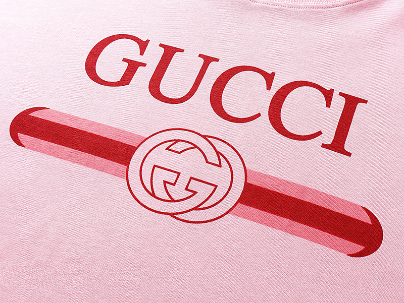 Pink T-shirt chest print featuring GUCCI letters and red bar logo graphic