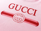 Pink T-shirt chest print featuring GUCCI letters and red bar logo graphic