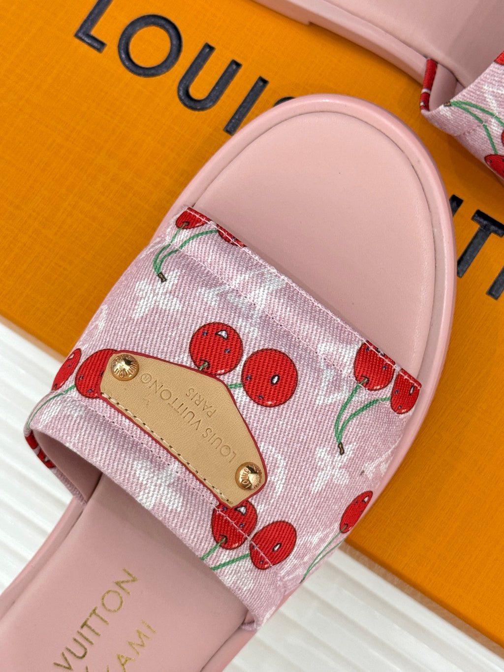 Cherry-print slide sandals with gold-tone buckle on pink cushioned footbed