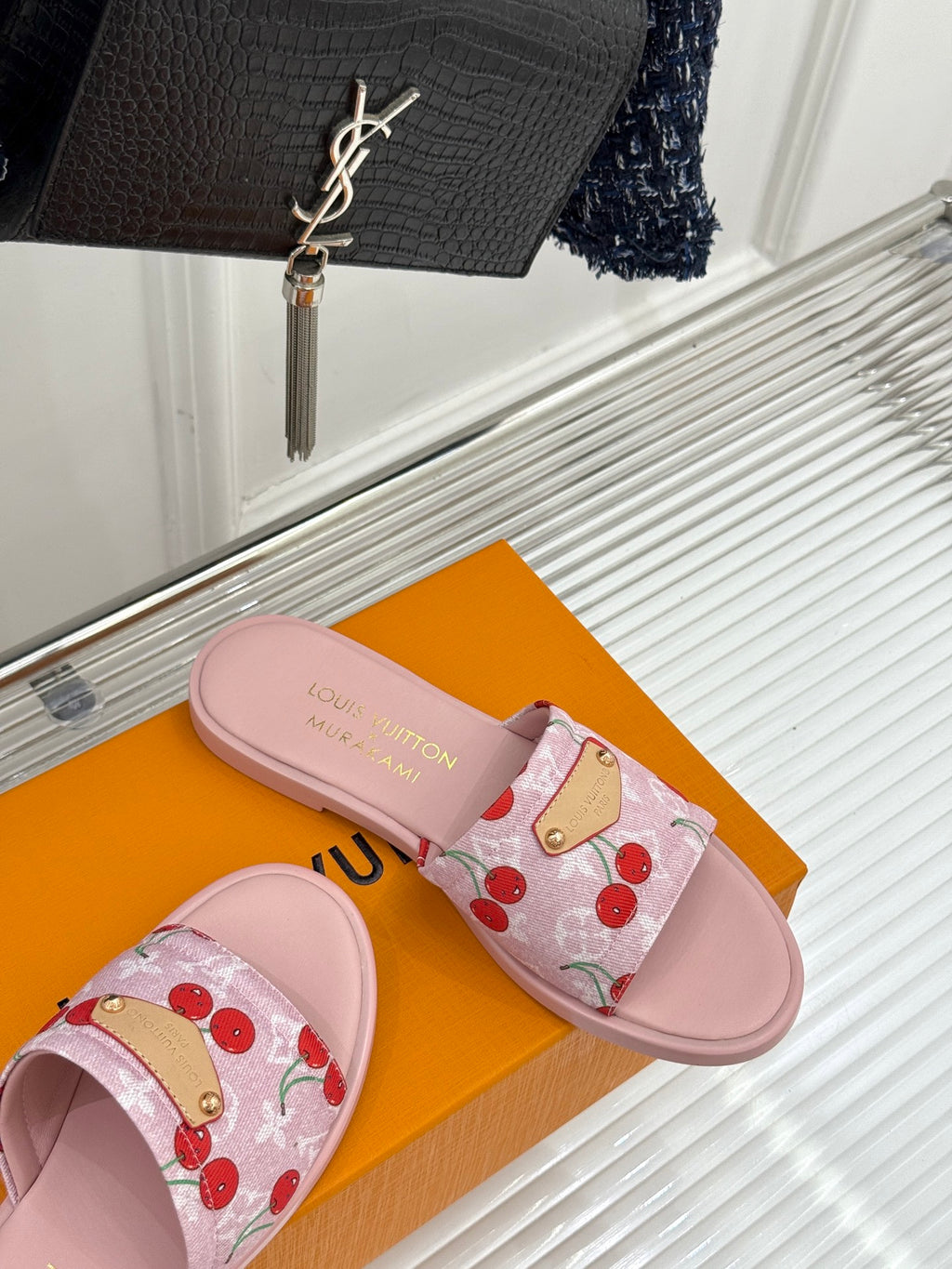 Pink slide sandals with cherry print fabric straps and gold-tone buckle detail