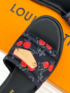 Louis Vuitton women's slide sandal close-up: cherry-pattern strap with beige leather tag.