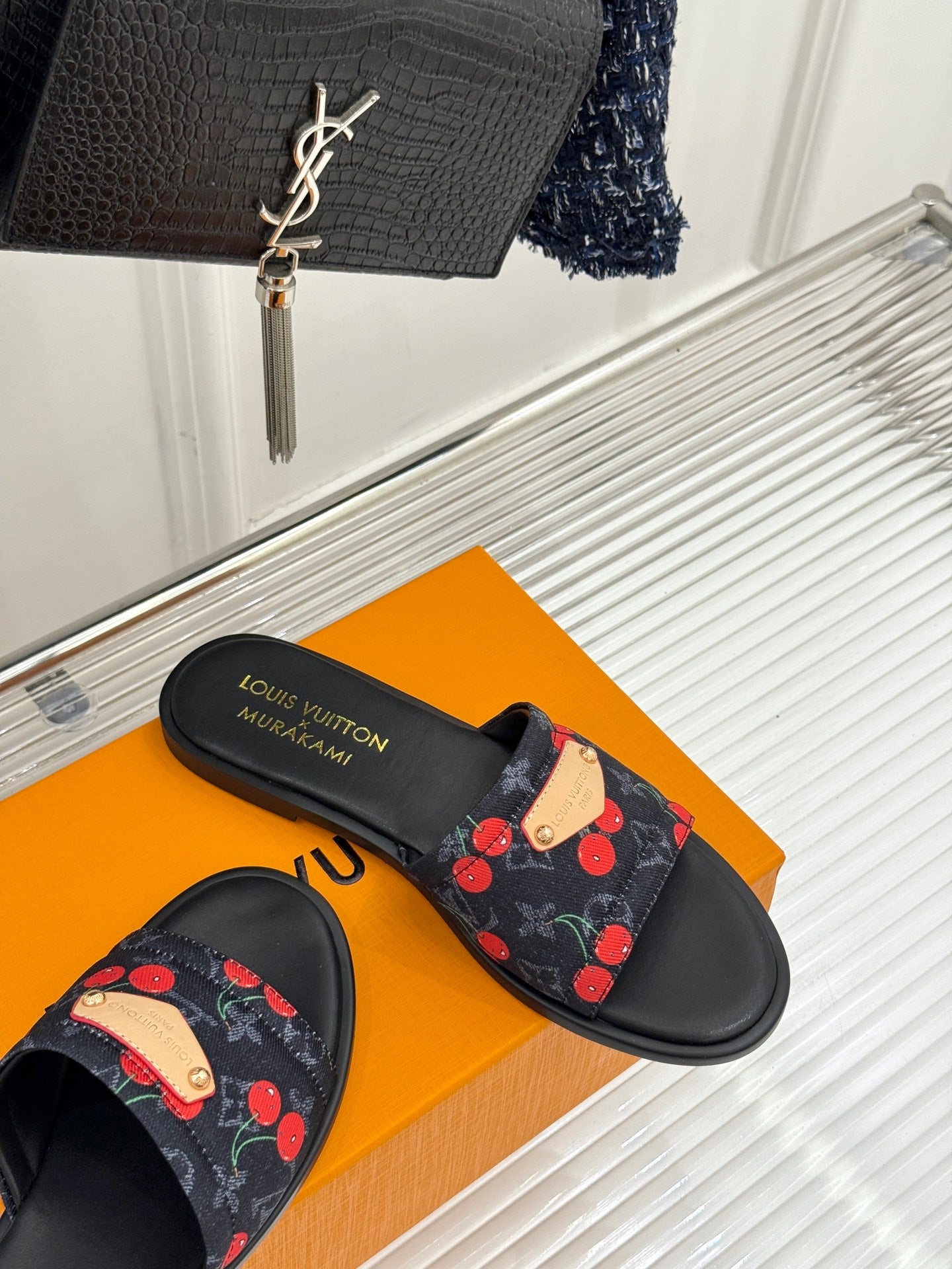 Louis Vuitton women's slide sandals with cherry-print fabric strap, black sole on box.