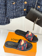 Louis Vuitton women's slide sandals with cherry print strap and gold detail.