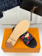 Louis Vuitton women's slide sandals with beige outsole and cherry-print strap on box.