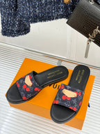 Louis Vuitton women's slide sandals on box, black cherries on fabric strap.