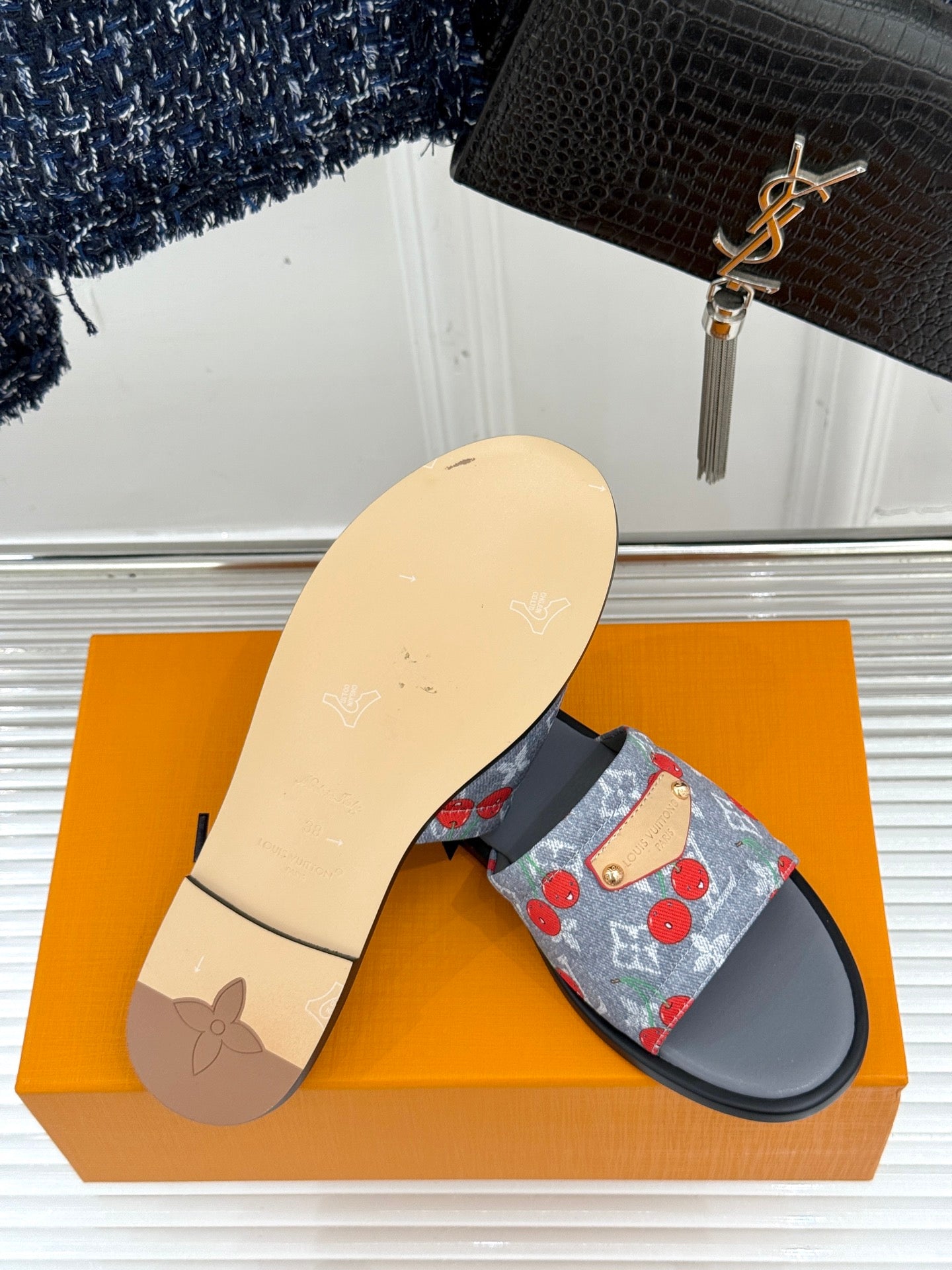Women’s slide sandals, single pair view: blue cherry-print strap on gray sole