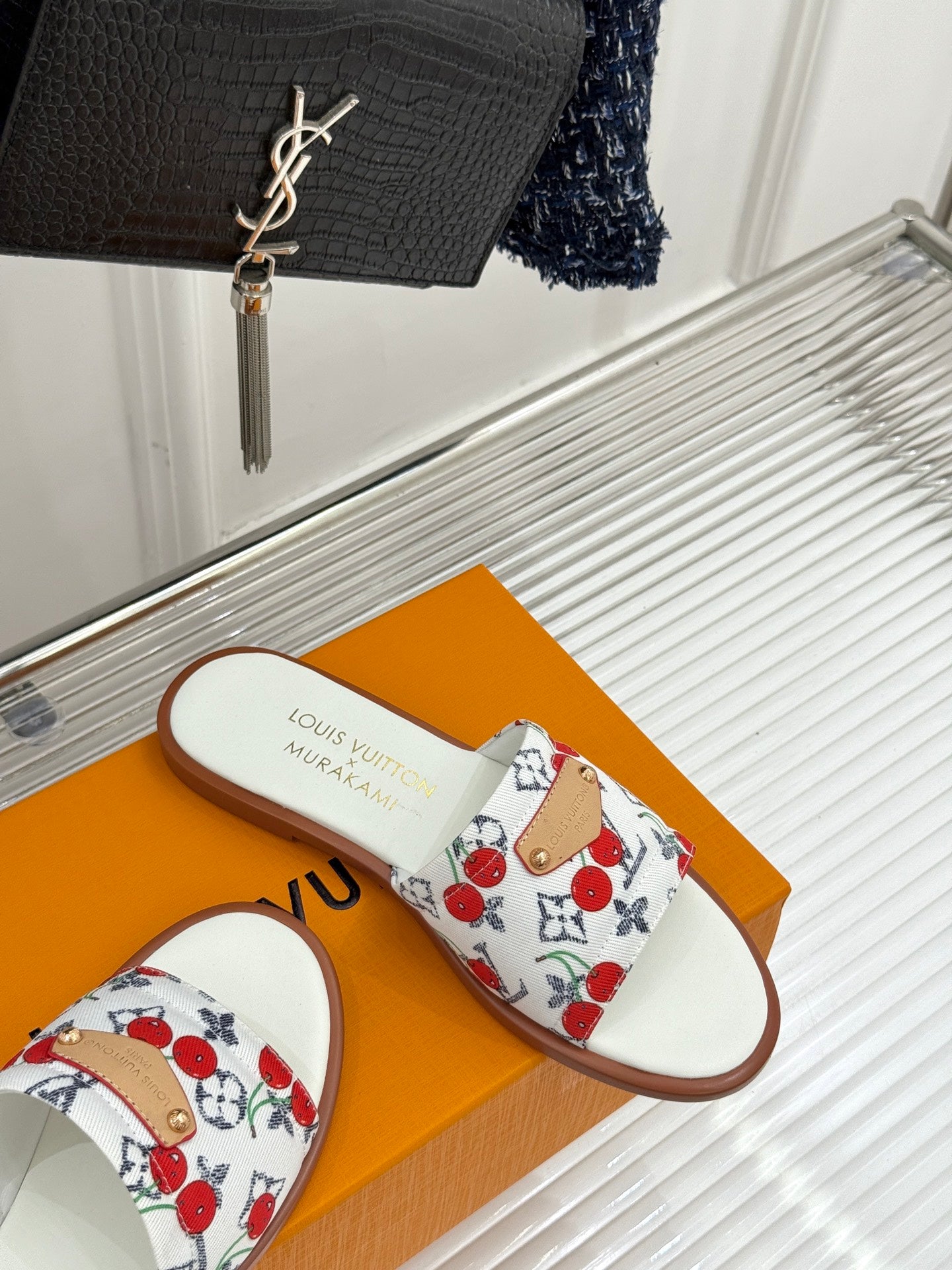 Single ladies slide sandal with white cherry-pattern strap and brown sole