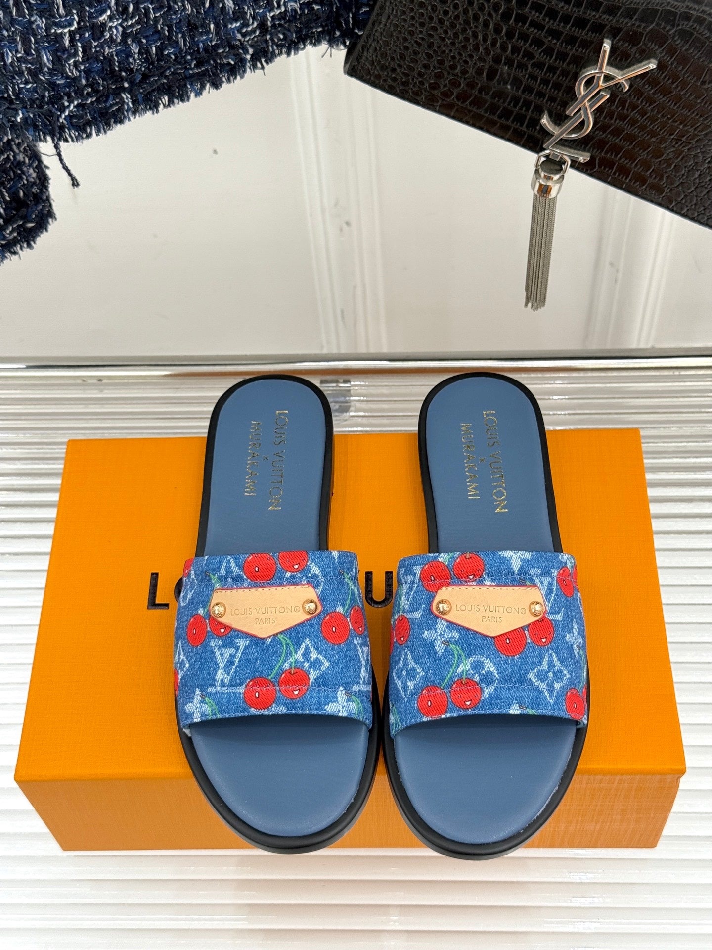 Louis Vuitton pair of denim slide sandals with blue base and red cherry patterned straps