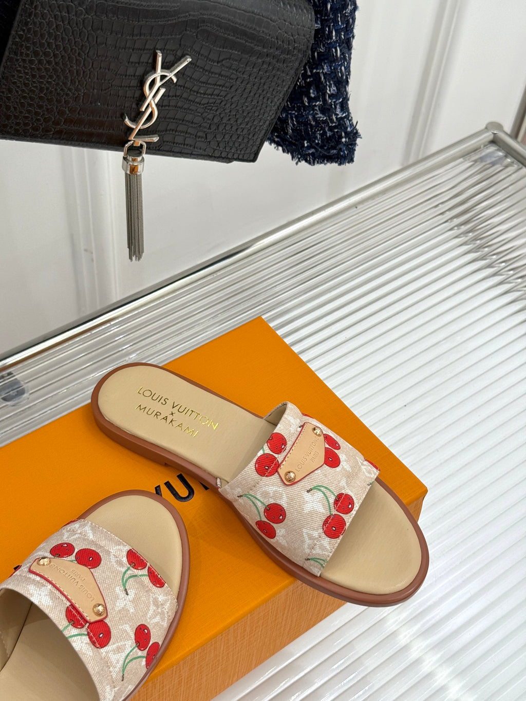 Louis Vuitton cherry-print slide sandals with fabric strap and tan sole, side view