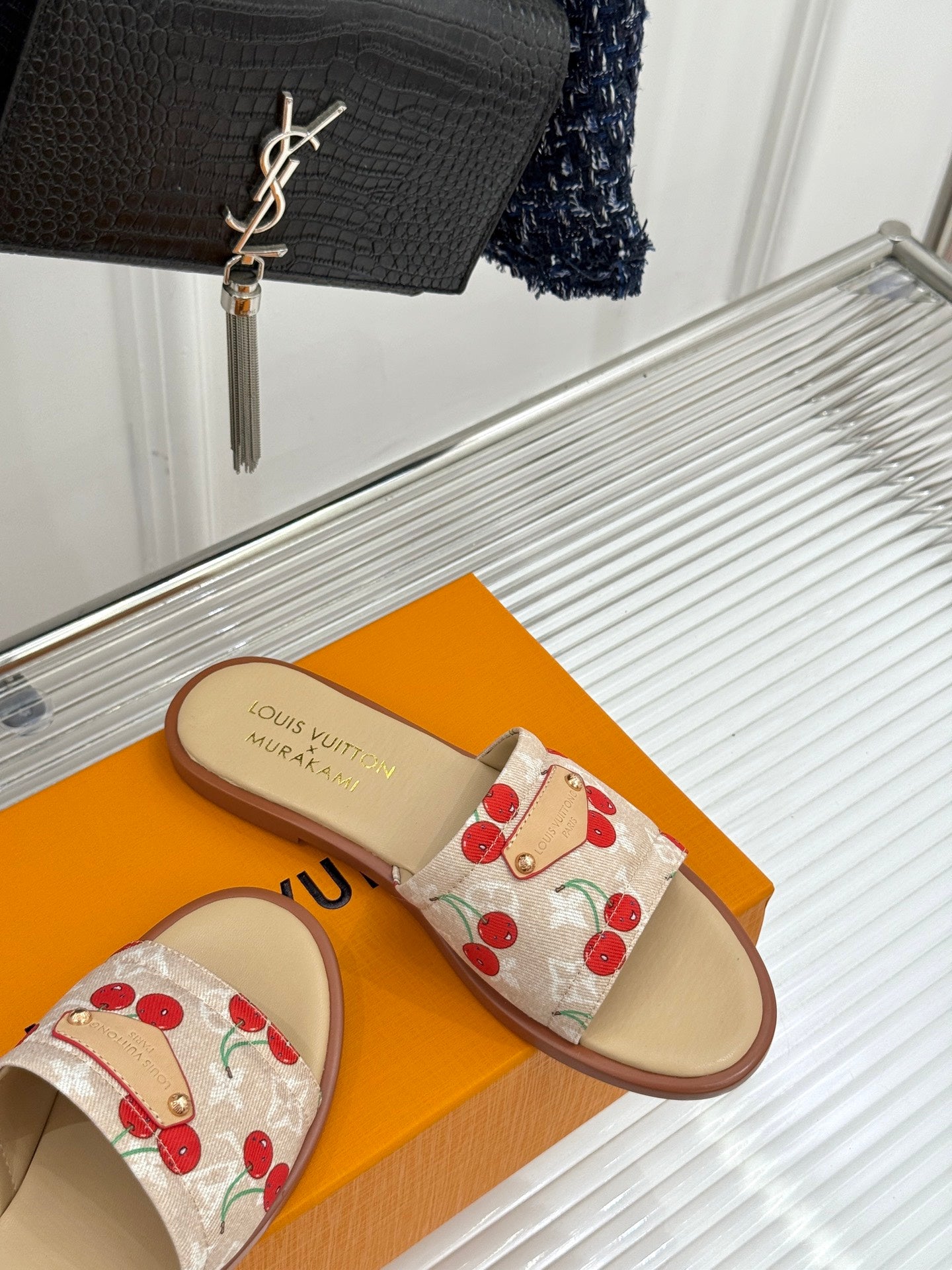 Louis Vuitton cherry-print slide sandals with fabric strap and tan sole, side view