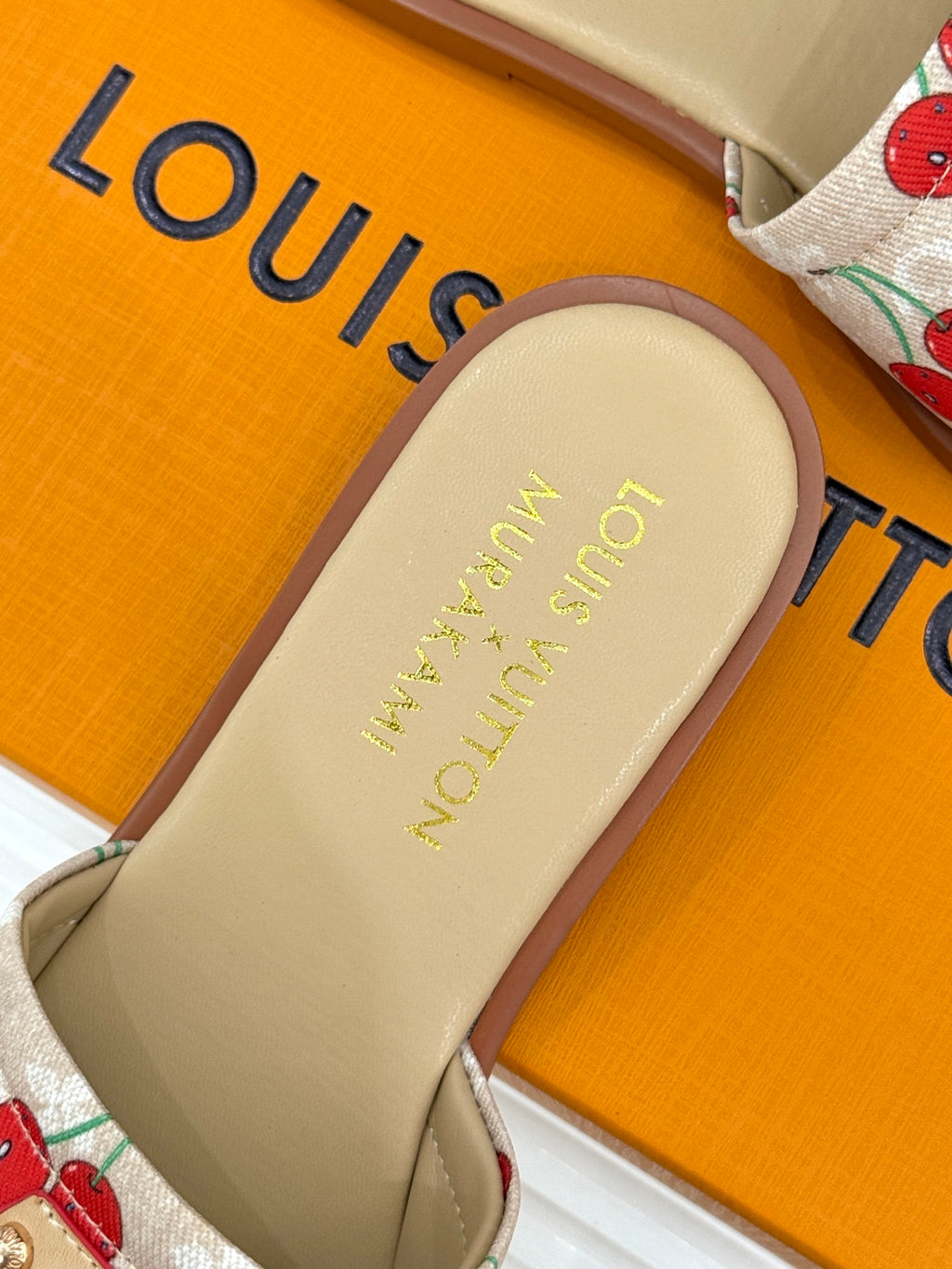 Louis Vuitton slide sandal footbed with gold logo and cherry-pattern strap