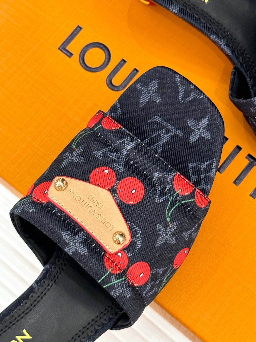 Women’s Louis Vuitton cherry print slide mule with gold-stud buckle detail