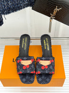 Women’s Louis Vuitton logo cherry print slide mules, front view on orange box