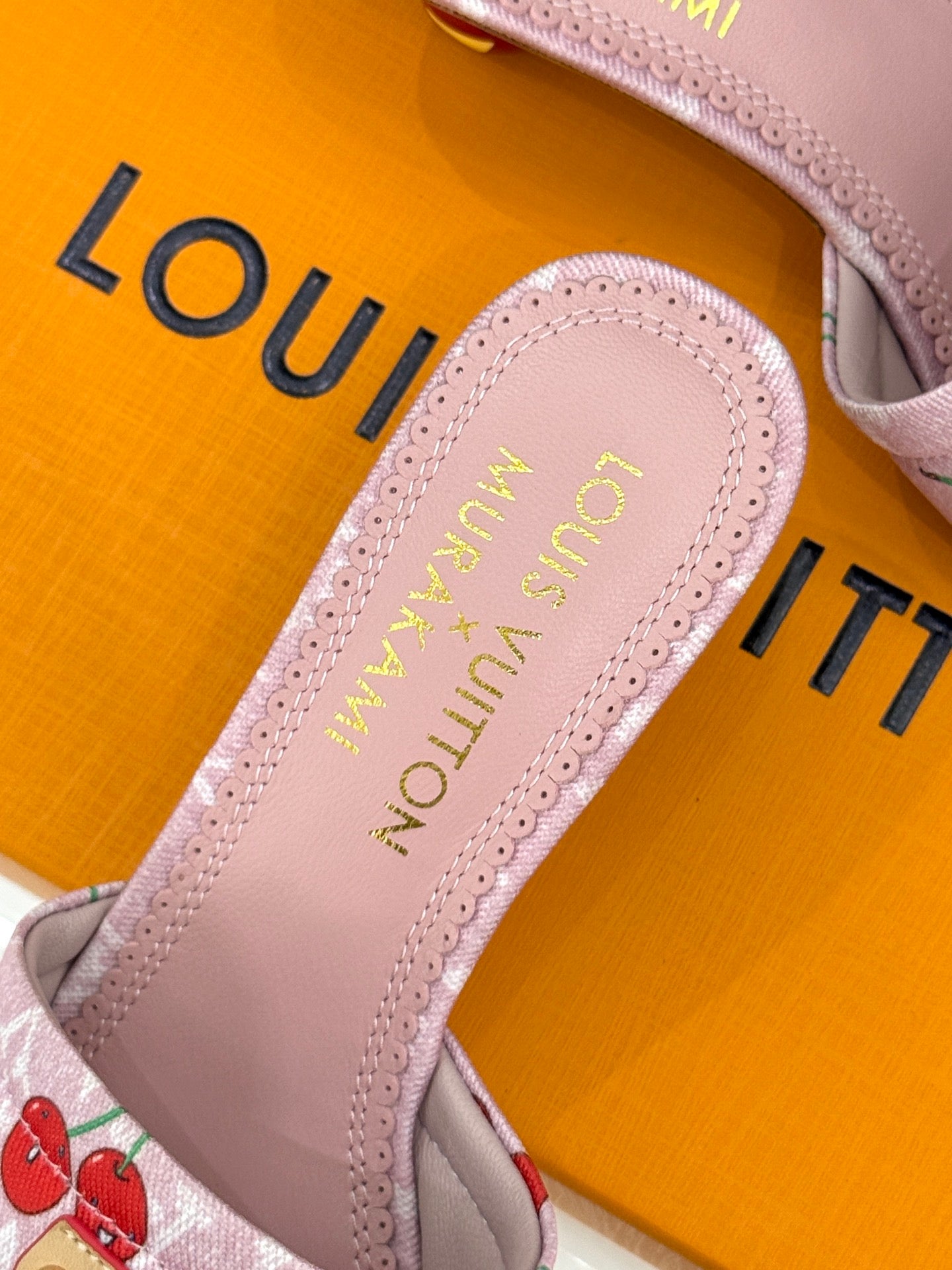 Pink Louis Vuitton sandal insole with gold lettering and scalloped trim