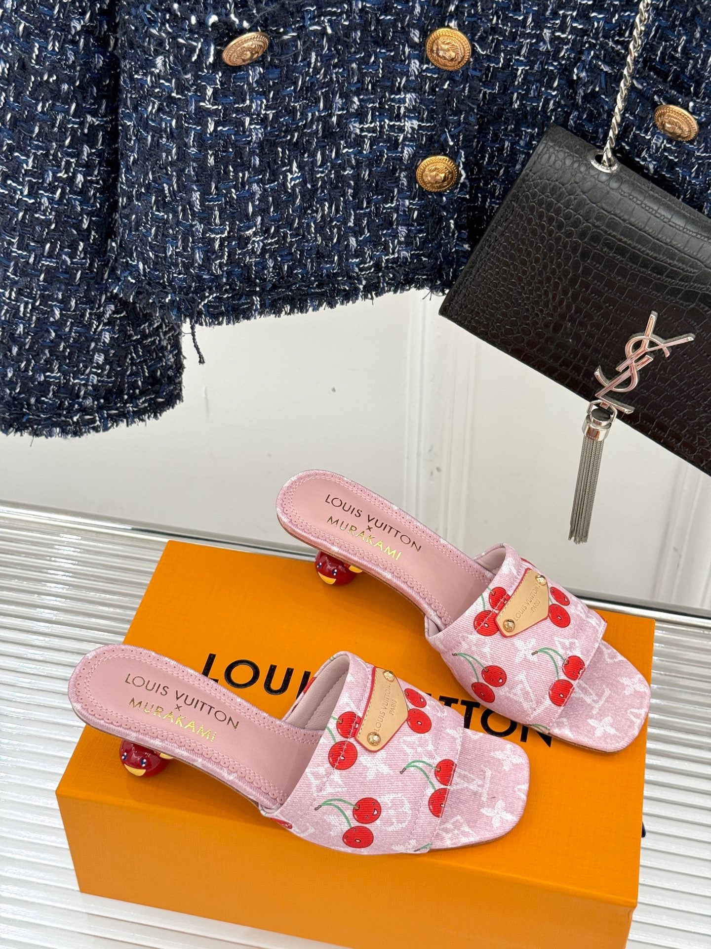 Pink cherry-print Louis Vuitton mule sandals with gold buckle patch and low heel