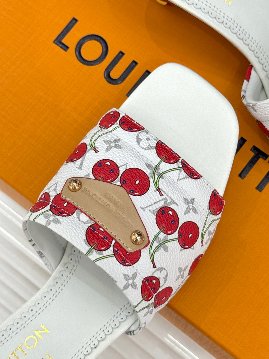 Louis Vuitton women's white cherry-print slide strap with gold buckle on upper