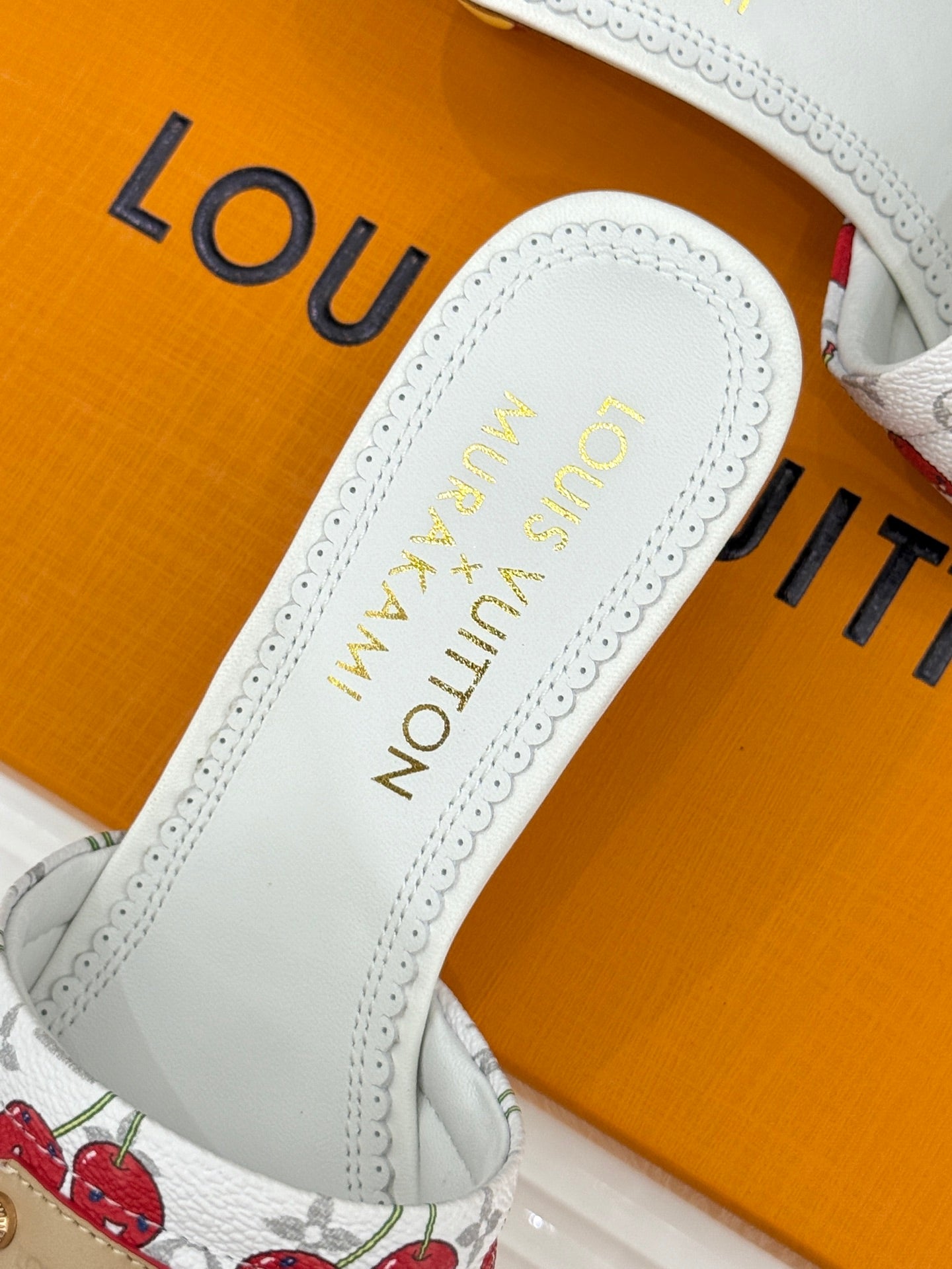 Louis Vuitton women's white leather slide sandal with embroidered-style logo on footbed