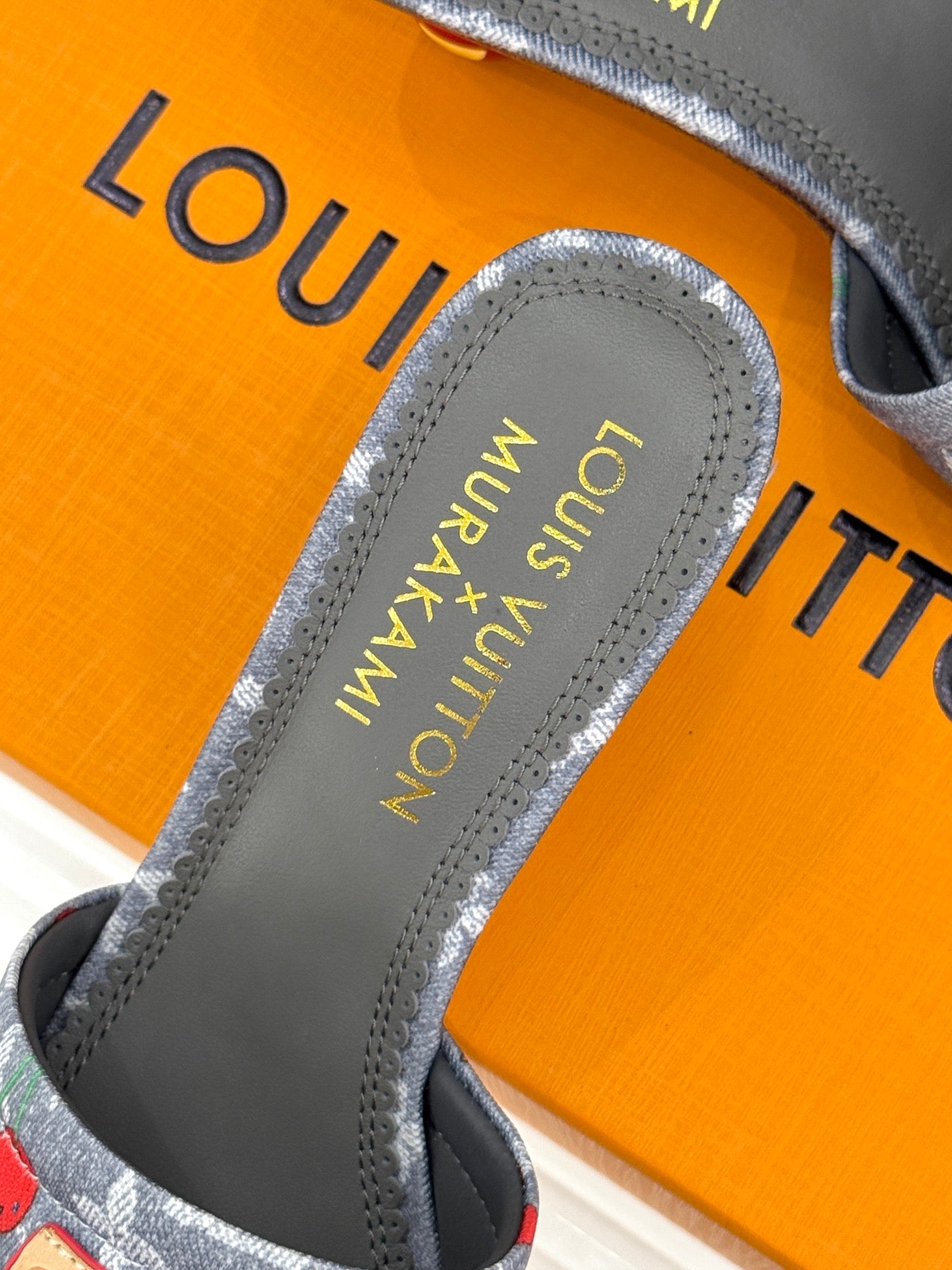 Louis Vuitton gray slide sandal sole and logo, cherry-print upper close view