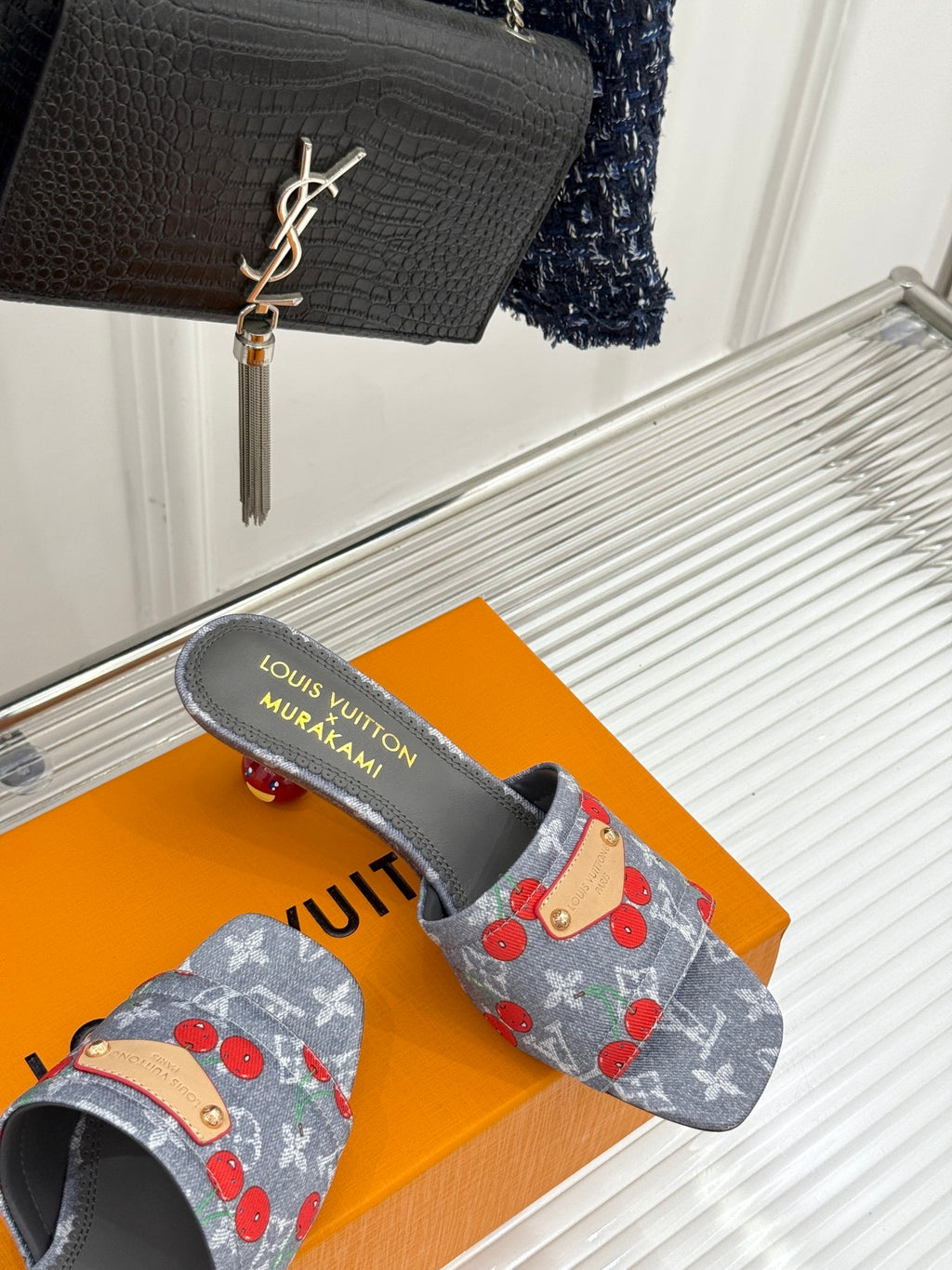 Louis Vuitton gray cherry slide sandals with tan leather patch, side view