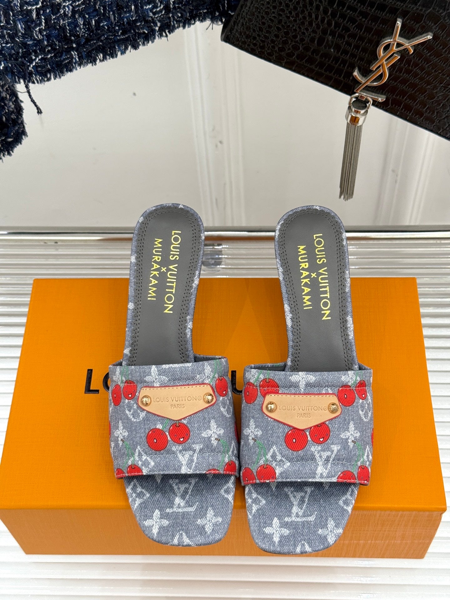 Louis Vuitton gray slide sandals pair with cherry print uppers and tan leather straps