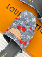 Louis Vuitton gray slide sandals close-up of cherry print and tan logo patch