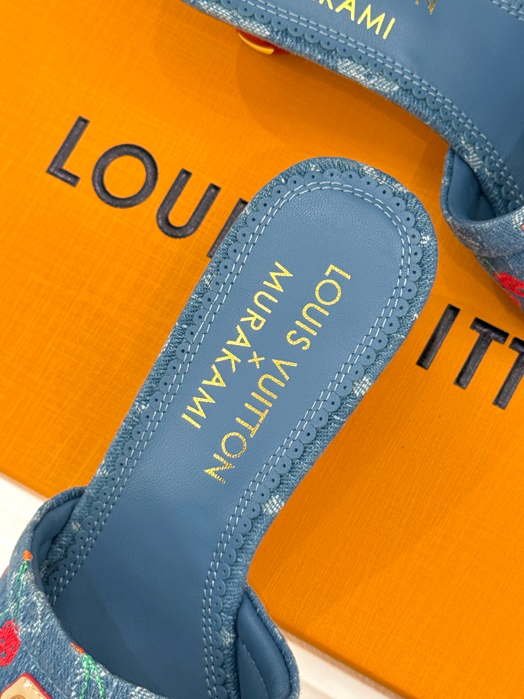 Louis Vuitton blue mule footbed with gold-printed logo and stitched edging