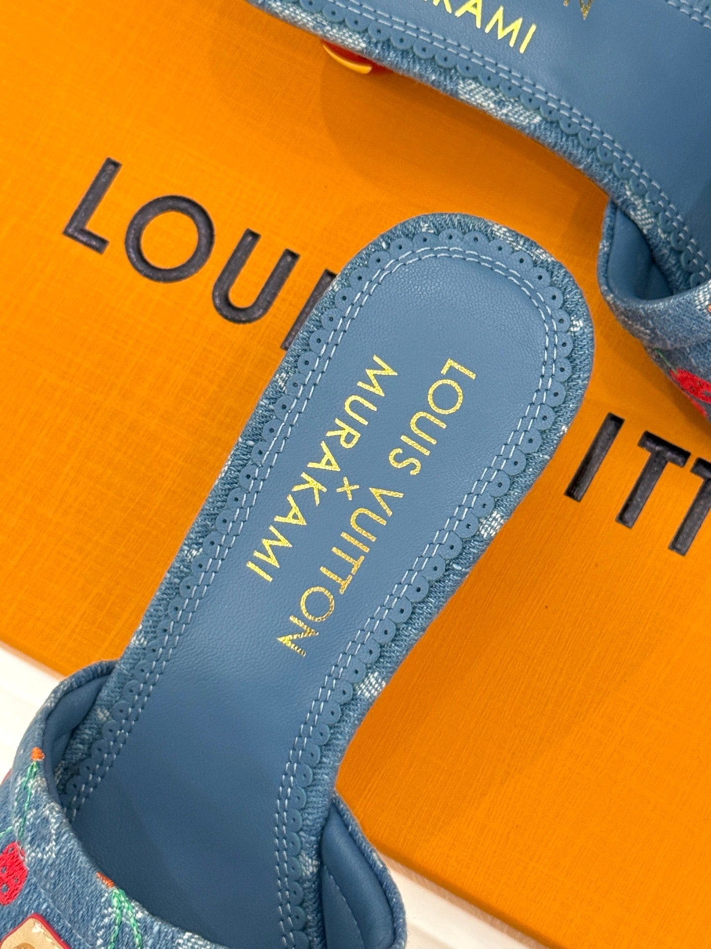 Louis Vuitton blue mule footbed with gold-printed logo and stitched edging