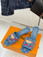 Louis Vuitton blue denim slide mules with red cherry pattern, gold buckle and logo text