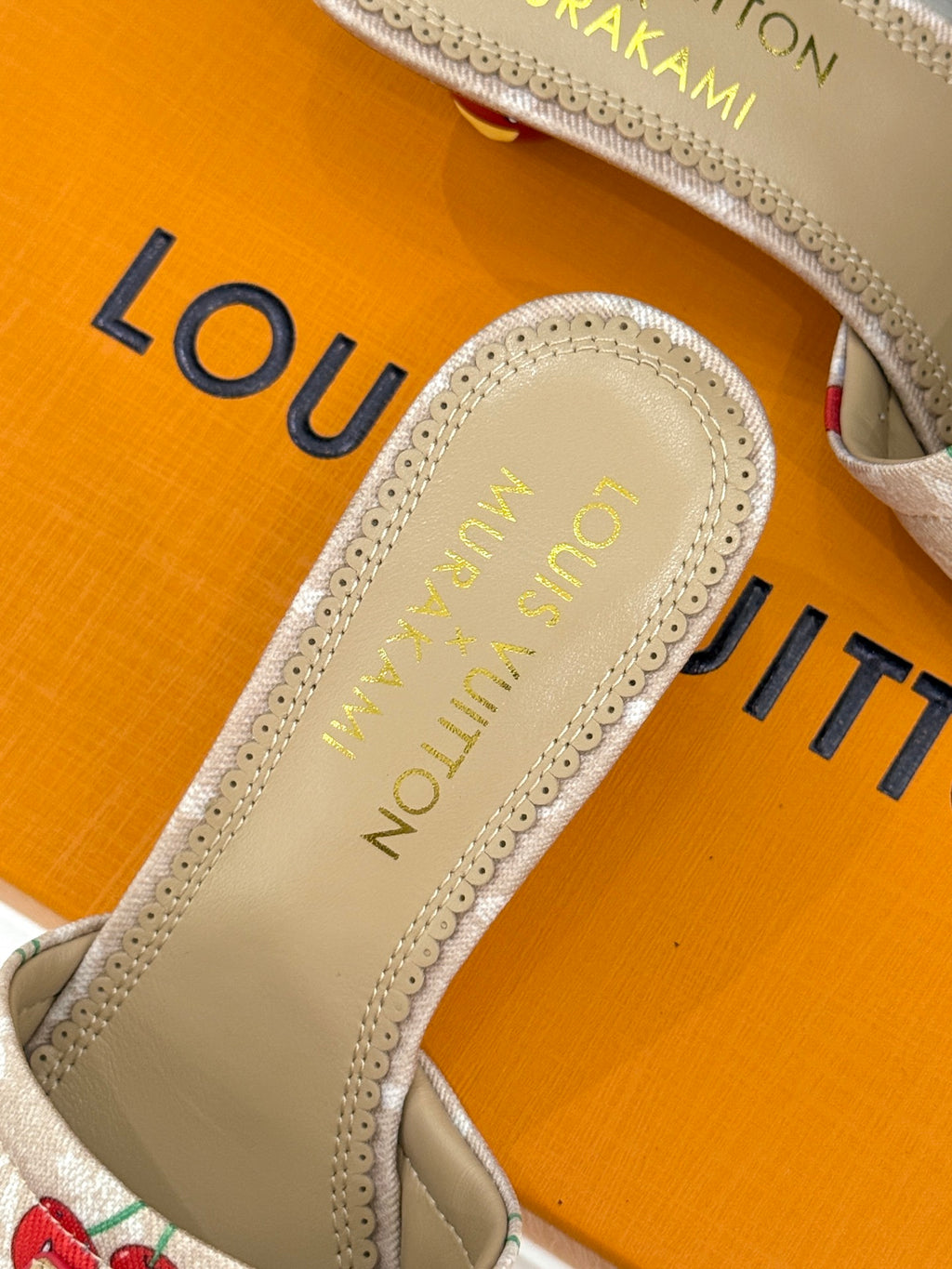 Close-up of beige sandal footbed with gold Louis Vuitton logo text.
