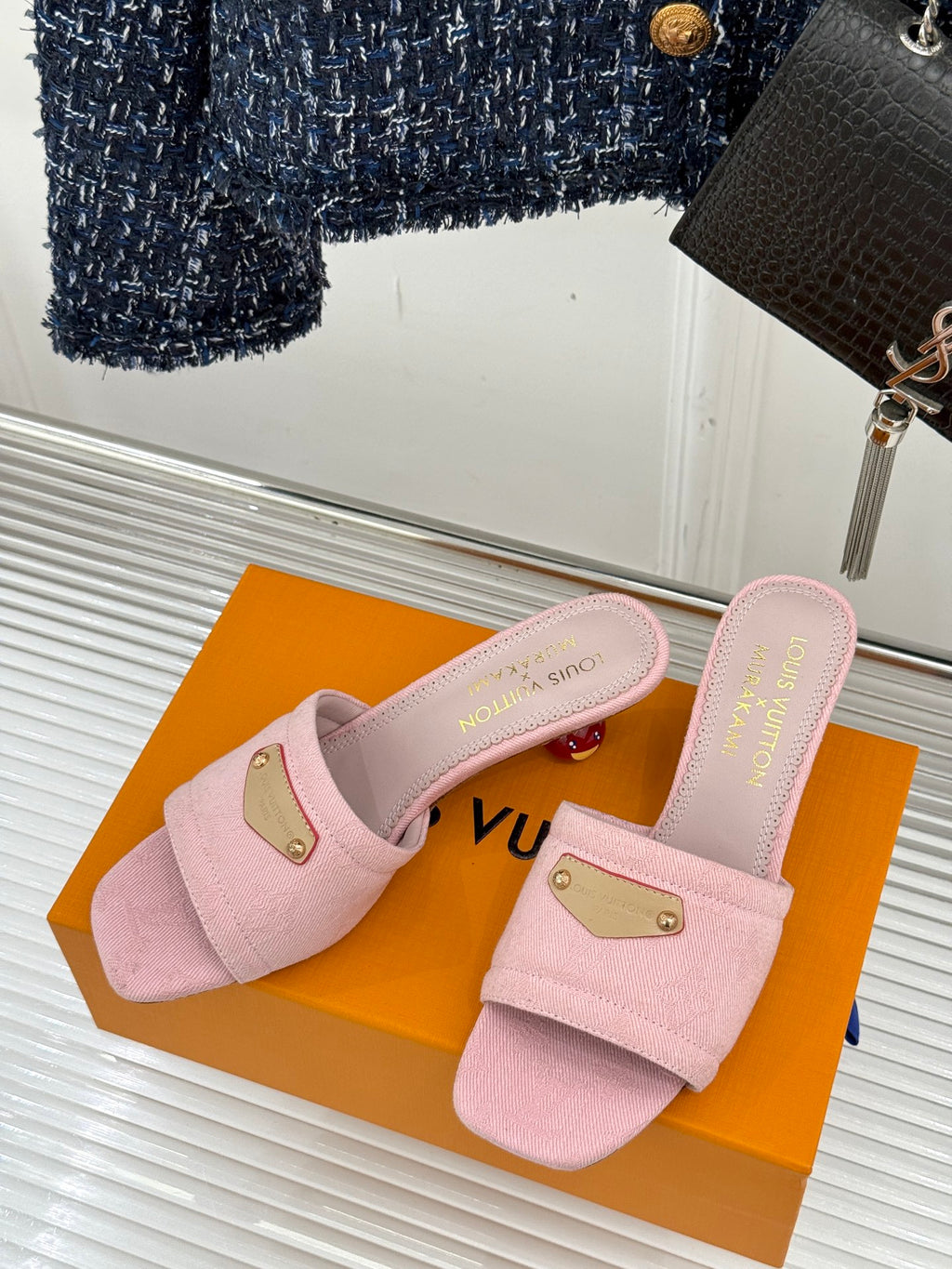Pink slide sandals with gold buckle on straps, shown as a pair