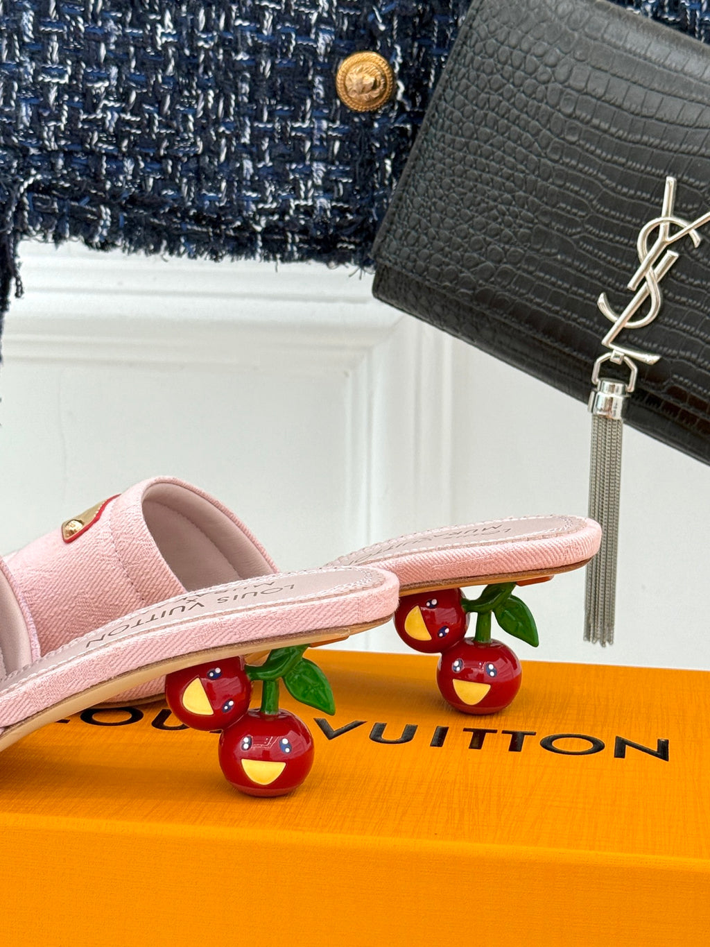 Pink slide sandals with gold buckle plate, shown in side profile