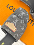 Women's gray monogram mule with close-up tan studded front plate and stitching