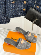 Women's gray monogram mule slides on orange box, tan buckle accent at front