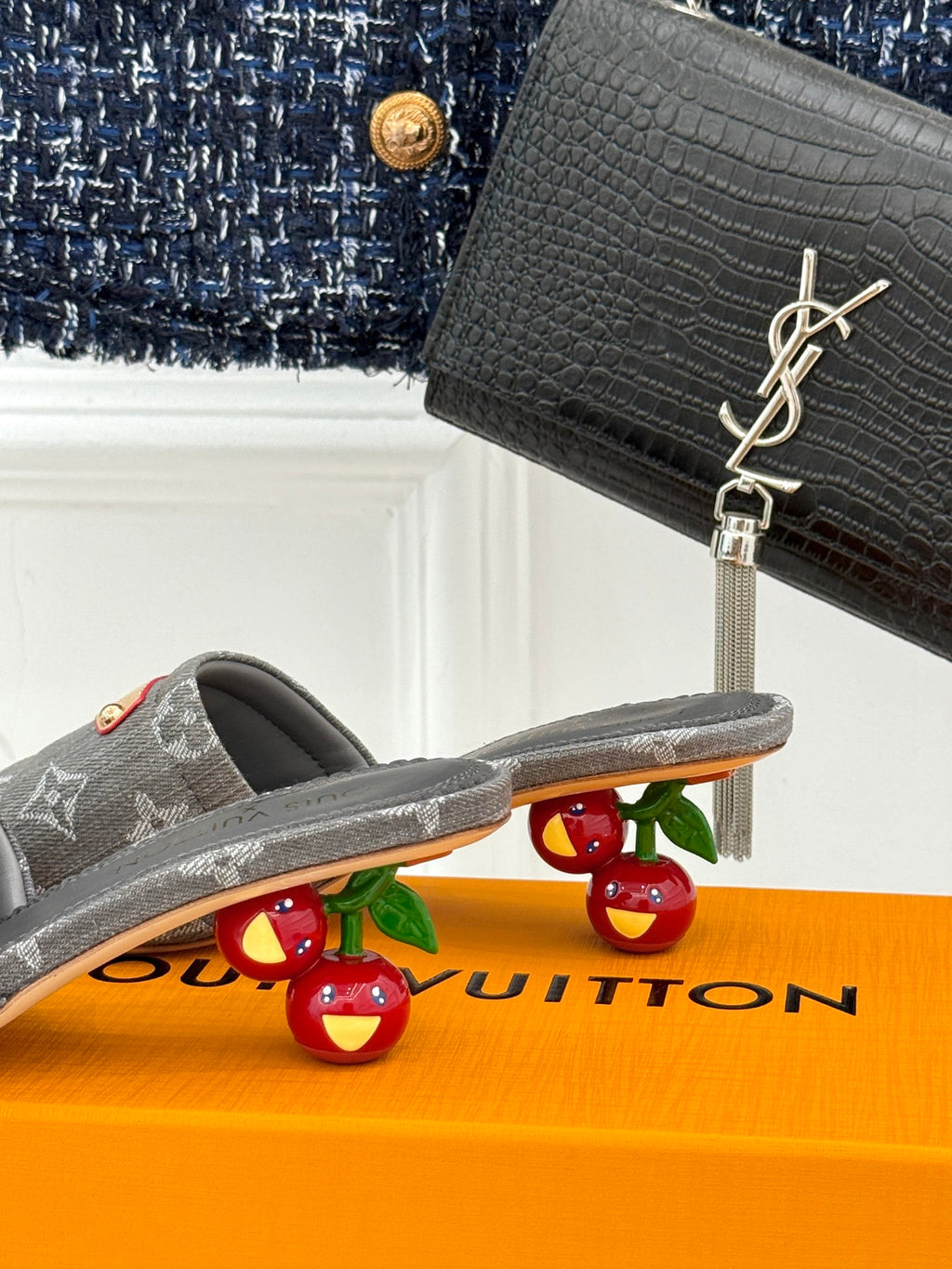 Women's gray monogram mule slide with open toe and tan buckle on front strap