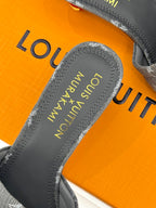 Women's gray monogram mule slide showing gray footbed text and padded lining