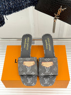 Women's gray monogram mule slides with gray heel slip lining and tan stud plate