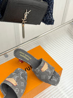 Women's gray monogram mule slides with tan buckle detail and textured gray sole