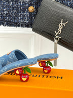 Blue Monogram slide sandals with tan logo patch and textured footbed