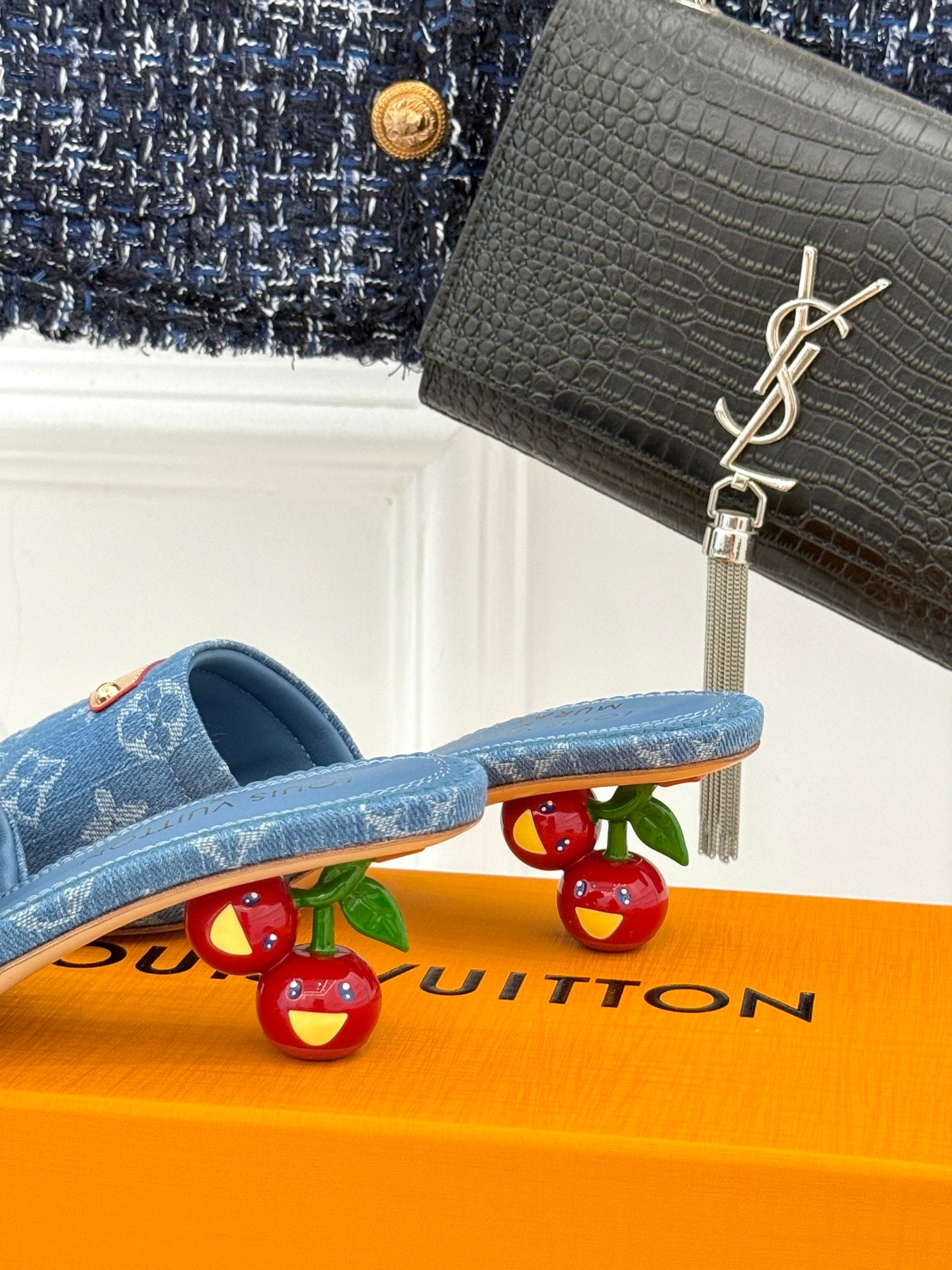 Blue Monogram slide sandals with tan logo patch and textured footbed