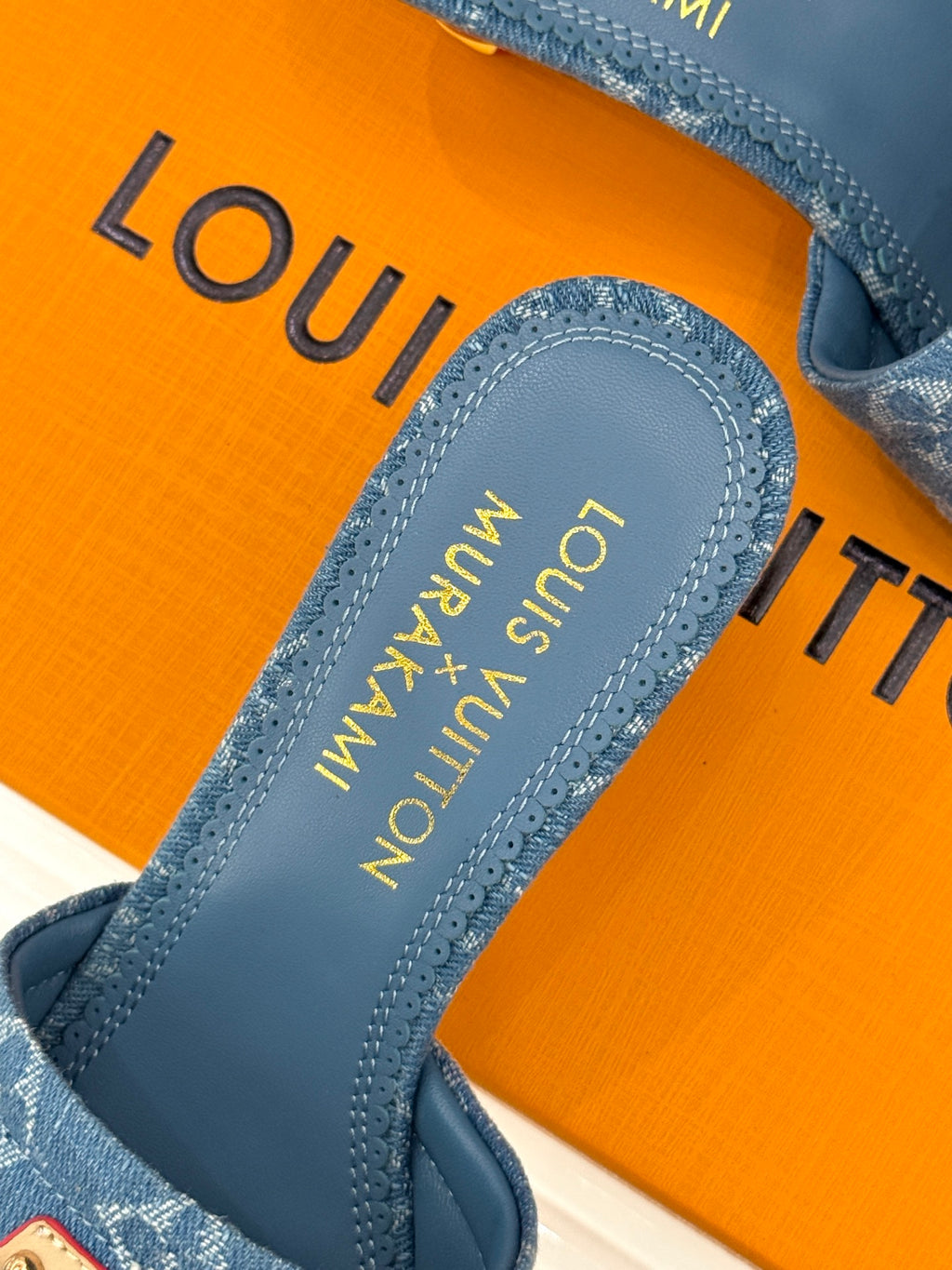 Close-up of blue Monogram slide sandal footbed with brand lettering