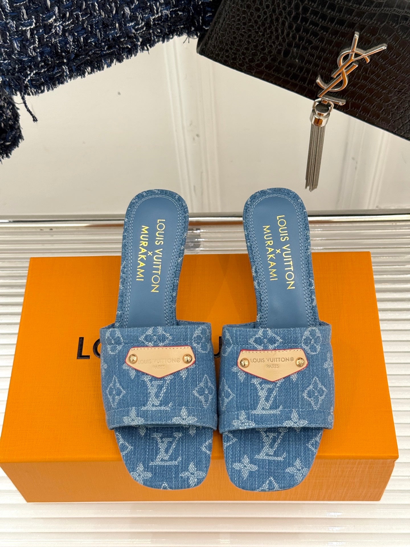 Blue Monogram slide sandals with two straps and branded blue insoles