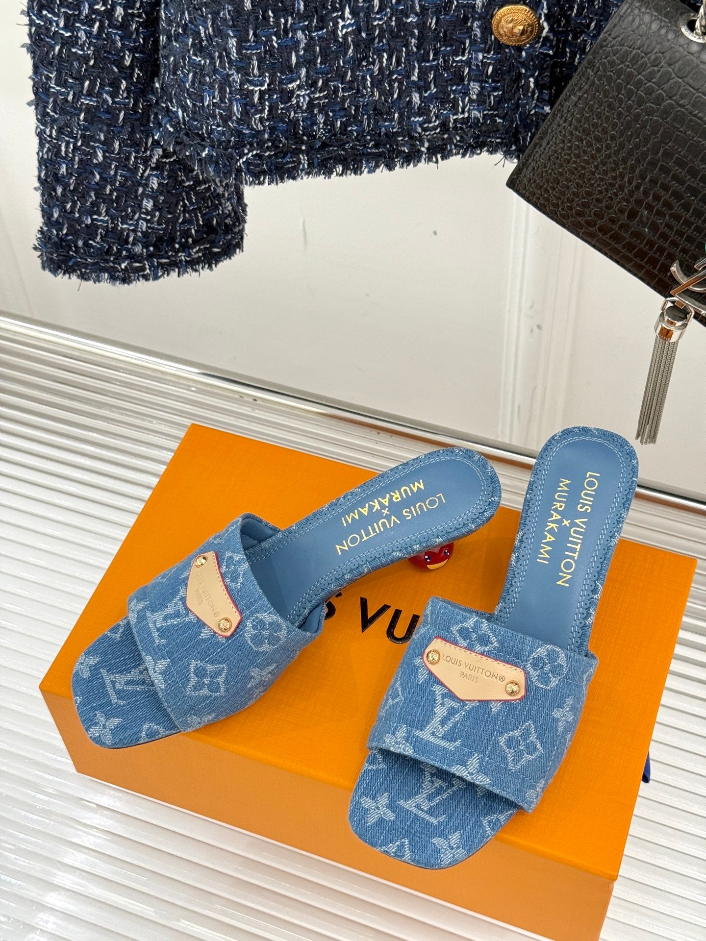 Blue Monogram slide sandals with tan logo tab straps and cushioned footbed