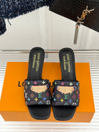 Black open-toe slide sandals with colorful monogram-pattern cross-strap
