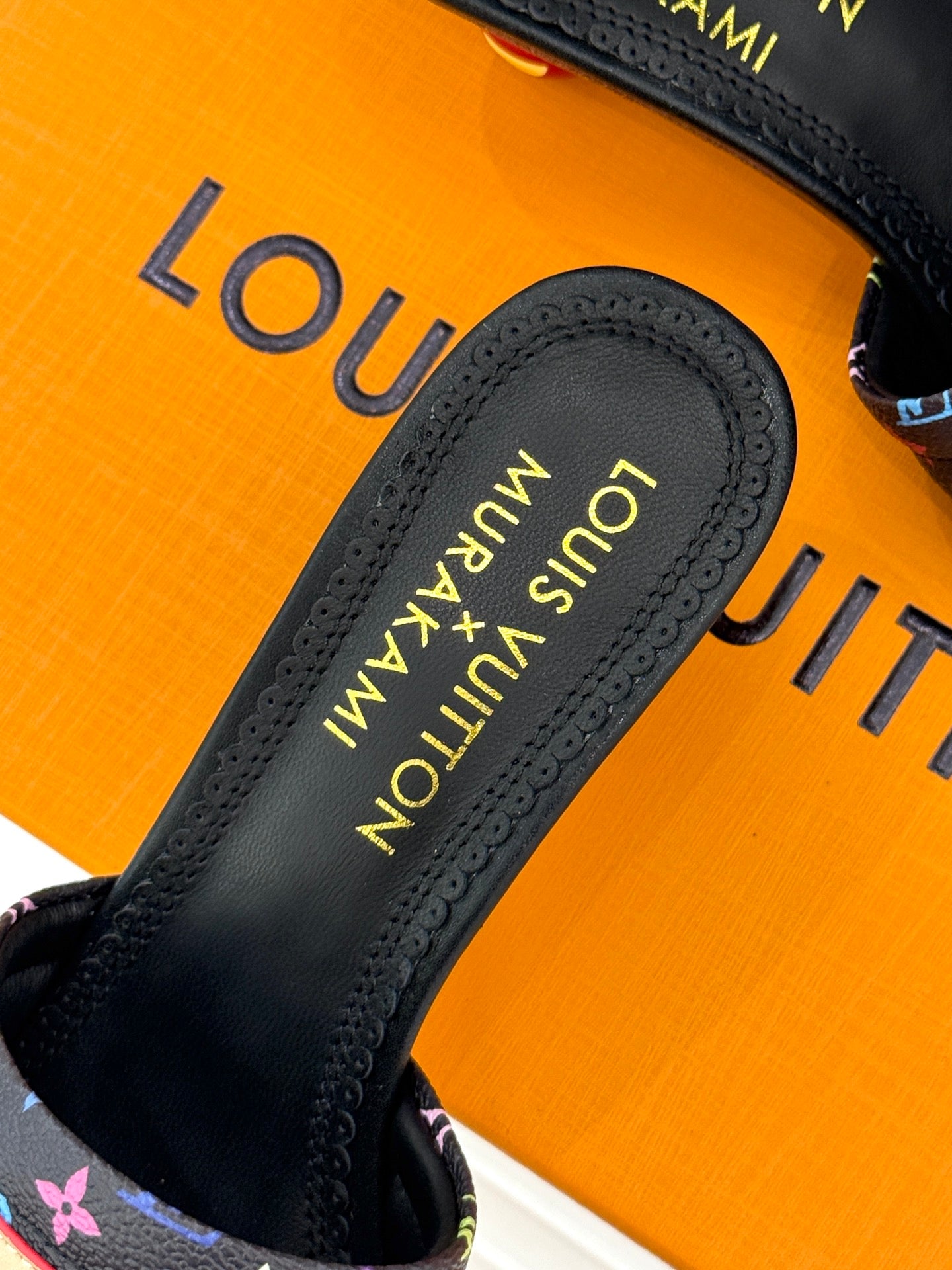 Black slide sandal with branded insole and multicolor monogram-pattern strap