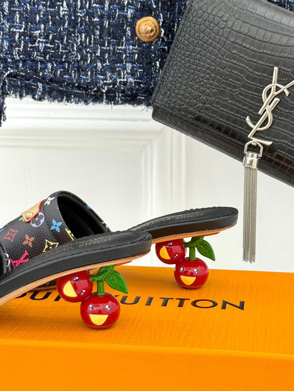 Black slide sandals with multicolor monogram-pattern strap and thin flat sole