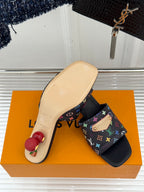 Black slide sandals with multicolor monogram-pattern strap and beige footbed