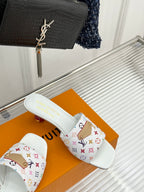 White slide sandals with multicolor monogram strap and open toe